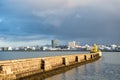 Lighthouse on sea pier in reykjavik iceland. Lighthouse yellow bright tower at sea shore. Seascape and skyline with