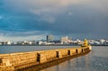 Lighthouse on sea pier in reykjavik iceland. Lighthouse yellow bright tower at sea shore. Seascape and skyline with