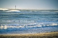 Lighthouse in the sea during windstorm with seagulls