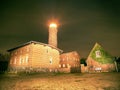 Lighthouse searchlight beam through dark night. Lighthouse at Darsser Ort near Prerow,