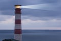 Lighthouse searchlight beam through marine air Royalty Free Stock Photo