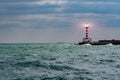 Lighthouse searchlight beam through marine air. Lighthouse In Stormy Landscape - Leader And Vision Concept