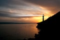Lighthouse searchlight beam through marine air at night. Royalty Free Stock Photo