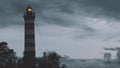 Lighthouse shines near the shore at sunset with dramatic sky Royalty Free Stock Photo