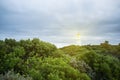 Lighthouse shining protective light over ocean Royalty Free Stock Photo