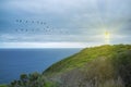 Lighthouse shining protective light over ocean