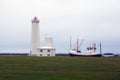 Lighthouse and ship on a clouds day in Iceland