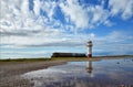 Lighthouse on the shoreline at Millom, Cumbria. Royalty Free Stock Photo