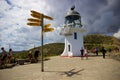 Lighthouse and signpost at Cape Reinga, Northland, New Zealand Royalty Free Stock Photo