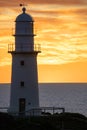 Lighthouse Silhouette Against The Backdrop Of The Ocean And Sunset, Orange Evening Sky And Clouds,
