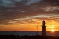Lighthouse Silhouette Against The Backdrop Of The Ocean And Sunset, Evening Clouds Sky And Clouds,