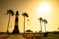 Lighthouse Silhouette Among Golden Sunset Sea