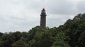 The lighthouse and the sky in the middle of the trees. Royalty Free Stock Photo