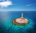 Lighthouse on smal island in the sea at sunny day in summer Royalty Free Stock Photo