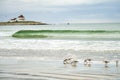 Lighthouse with small wave and birds