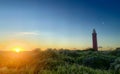 Lighthouse standing on the Dutch coast with a dramatic. and colorful sunset or sunrise sky behind it Royalty Free Stock Photo