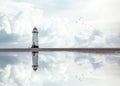 Lighthouse standing pool of water stunning dramatic storm clouds reflection reflected water sea steps up to building Wales sea Royalty Free Stock Photo