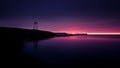 Lighthouse standing on a rocky coast with a purple sunset sky in Nova Scotia. Royalty Free Stock Photo