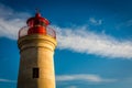 Lighthouse sunset with blue sky and clouds