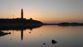 A lighthouse at sunset on a calm day