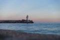 Lighthouse at sunset overlooking the calm sea