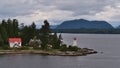 Lighthouse ta Dryad Point near Bella Bella on Campbell Island, Canada at Lama Passage, part of popular Inside passage. Royalty Free Stock Photo