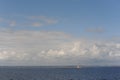 Lighthouse on a tiny uninhabited island in Skagerrak Strait between Sweden and Norway on a sunny day with blue sky, navy blue sea