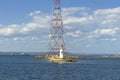 Lighthouse Tokarevskaya cat with power line on sunny day