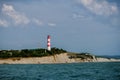 Lighthouse at the top of the hill over the sea Royalty Free Stock Photo