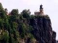 Lighthouse tower on coast on rocky near a lake.