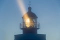 Lighthouse tower in the night with strong light beam