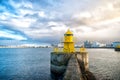 Lighthouse tower on stone pier in reykjavik, iceland. Lighthouse in sea. Seascape and skyline on cloudy sky. Architecture structur