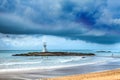 Lighthouse under Storm clouds over the sea Royalty Free Stock Photo