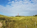 Lighthouse view through the dunes Royalty Free Stock Photo