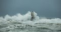 The lighthouse of the Mangiabarche shrouded by the waves of a mistral wind storm Royalty Free Stock Photo