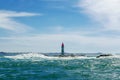 Lighthouse in waves Royalty Free Stock Photo