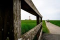 Lighthouse of Westerhever in Northern Germany, with people bicycling on the narrow walk path