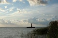 A lighthouse and white fluffy clouds Royalty Free Stock Photo