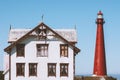 Lighthouse and white wooden old house in Norway traditional architecture