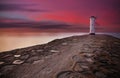 Lighthouse windmill with dramatic sunset sky