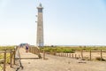 Lighthouse and wooden bridge with tourists in Morro Jable, Fuerteventura, Spain
