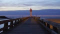 Lighthouse and wooden bridge of Trouville-sur-Mer, Normandy, France at sunset Royalty Free Stock Photo
