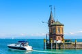 Lighthouse and yacht in harbor of Constance or Konstanz, Germany. Beautiful scenic view of Constance Lake Bodensee in summer Royalty Free Stock Photo