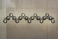 Lighting balls on the chandelier in the lamplight, light bulbs hanging from the long rail, silver pendant lamps on the light