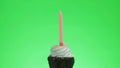 Lighting a blue candle on a delicious cupcake, green screen