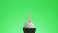 Lighting a blue candle on a delicious cupcake, green screen