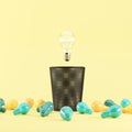 Lighting bulb floating on Bin Trash with colorful illumination bulb placed on a yellow background. 3D render