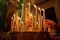 Lighting a candle in a church. candle church. A row of lighted wax candles in the Christian Orthodox Church on a dark blurred Royalty Free Stock Photo