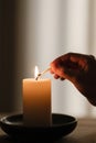 Lighting a Candle with a Match Royalty Free Stock Photo
