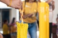 Lighting the candle pray to Buddha, big candle and Flame lit by the big candle`s fire Royalty Free Stock Photo